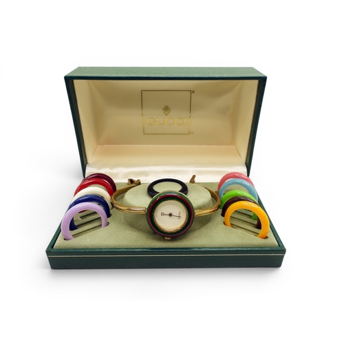 731 - A ladies Gucci 11/12 watch with interchangeable multi coloured bezels.