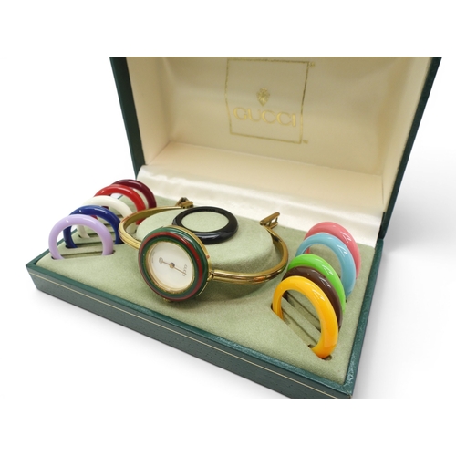 731 - A ladies Gucci 11/12 watch with interchangeable multi coloured bezels.