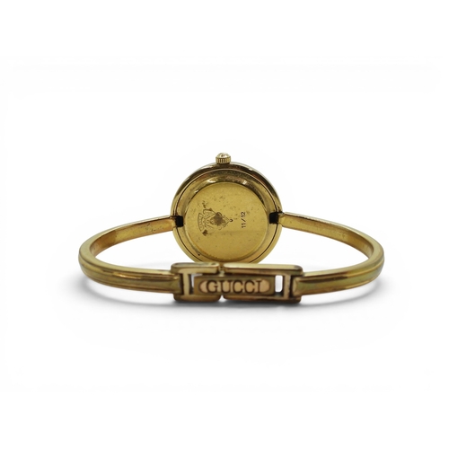 731 - A ladies Gucci 11/12 watch with interchangeable multi coloured bezels.