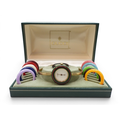 731 - A ladies Gucci 11/12 watch with interchangeable multi coloured bezels.