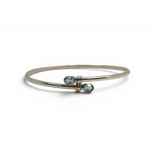 734 - A 9ct white gold bangle set with blue topaz, weight 4.1gms