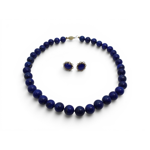 739 - A string of lapis lazuli beads with a 9ct gold clasp, together with a pair of matching earrings.