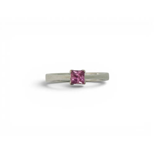 742 - An 18ct white gold ring set with a square cut pink sapphire, size O1/2, weight 3.4gms