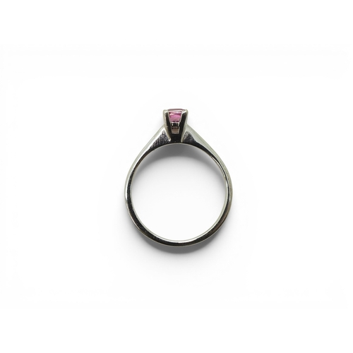 742 - An 18ct white gold ring set with a square cut pink sapphire, size O1/2, weight 3.4gms