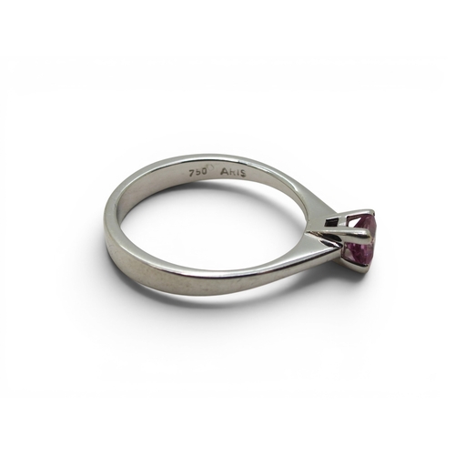 742 - An 18ct white gold ring set with a square cut pink sapphire, size O1/2, weight 3.4gms