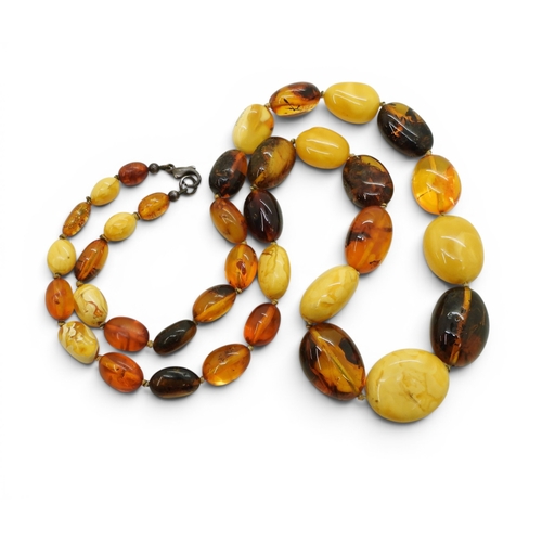 749 - A string of mixed amber coloured beads, length 64cm, largest bead 2.5cm to smallest 1cm, weight 52.8... 