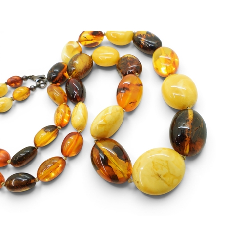 749 - A string of mixed amber coloured beads, length 64cm, largest bead 2.5cm to smallest 1cm, weight 52.8... 
