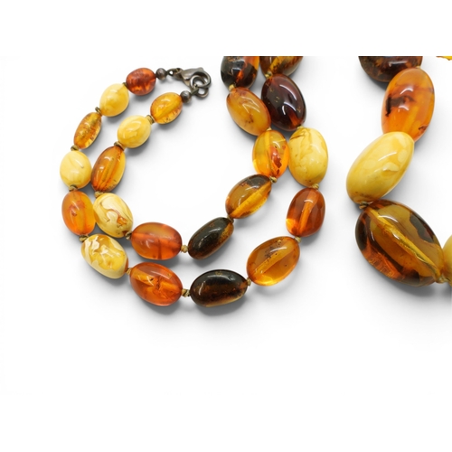 749 - A string of mixed amber coloured beads, length 64cm, largest bead 2.5cm to smallest 1cm, weight 52.8... 