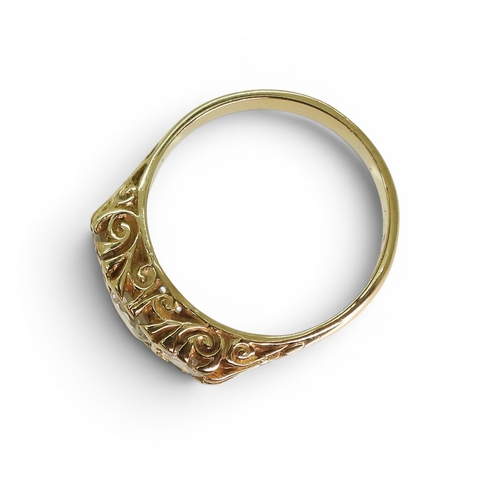 756 - A three clear gem set ring on a decorative scroll mount, size O, weight 3.4gms.