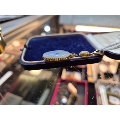 2733 - AN OPAL PENDANTthe mount is finely wrought in yellow metal, with galleried mounts and cut back setti... 