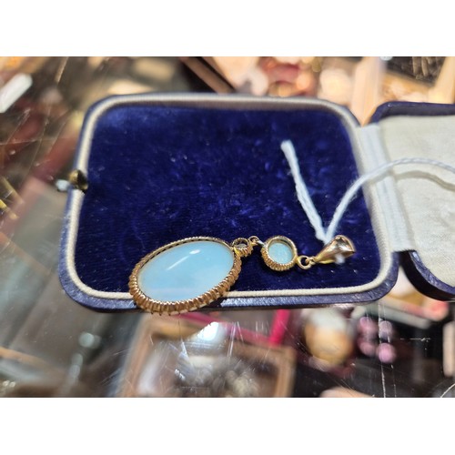 2733 - AN OPAL PENDANTthe mount is finely wrought in yellow metal, with galleried mounts and cut back setti... 