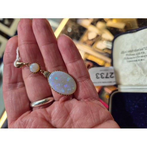 2733 - AN OPAL PENDANTthe mount is finely wrought in yellow metal, with galleried mounts and cut back setti... 