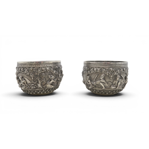 2403 - A PAIR OF BURMESE SILVER BOWLSwith all-over repousse decoration of deities, figures and animals, wit... 