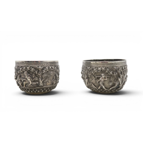 2403 - A PAIR OF BURMESE SILVER BOWLSwith all-over repousse decoration of deities, figures and animals, wit... 