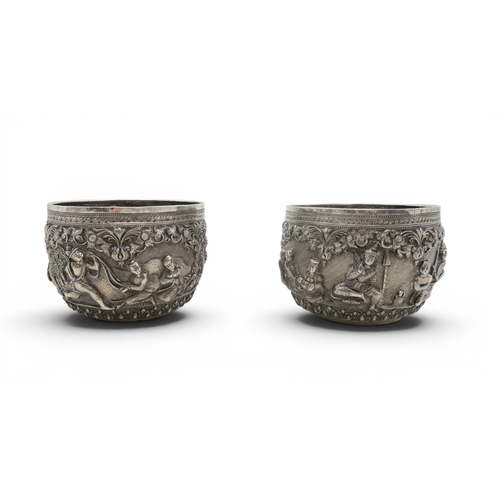 2403 - A PAIR OF BURMESE SILVER BOWLSwith all-over repousse decoration of deities, figures and animals, wit... 