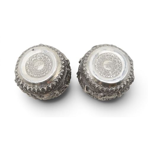 2403 - A PAIR OF BURMESE SILVER BOWLSwith all-over repousse decoration of deities, figures and animals, wit... 
