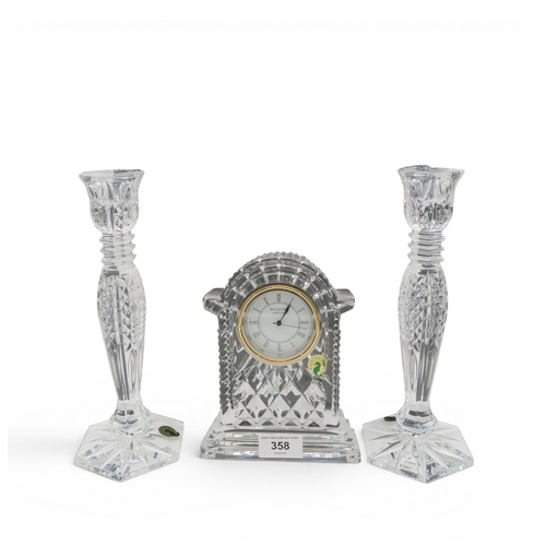 A pair of Waterford Bethany crystal candlesticks, boxed, together with a Waterford crystal clock