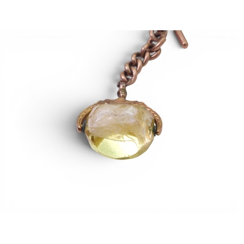 706 - A 9ct gold citrine fob seal with a short length a 9ct gold chain with a 'T' bar, together with a gla... 