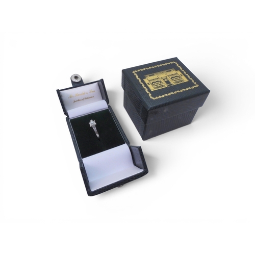 707 - A platinum and diamond three stone ring set with a GIA inscribed emerald cut diamond of estimated ap... 