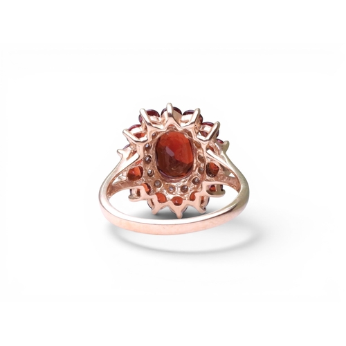 719 - A 9ct gold garnet and diamond accent ring, size P1/2, weight 3.8gms