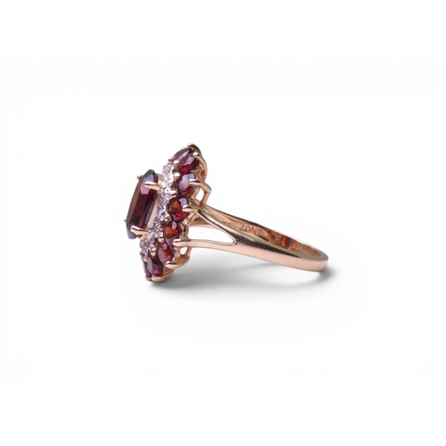 719 - A 9ct gold garnet and diamond accent ring, size P1/2, weight 3.8gms