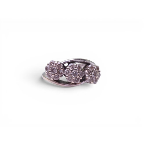720 - An 18ct white gold ring set with three diamond set flower clusters, with an estimated approx diamond... 