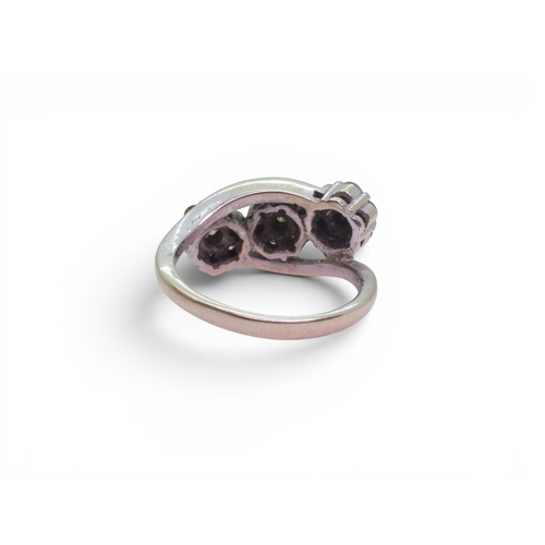 720 - An 18ct white gold ring set with three diamond set flower clusters, with an estimated approx diamond... 