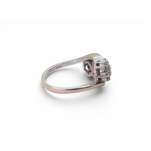 720 - An 18ct white gold ring set with three diamond set flower clusters, with an estimated approx diamond... 