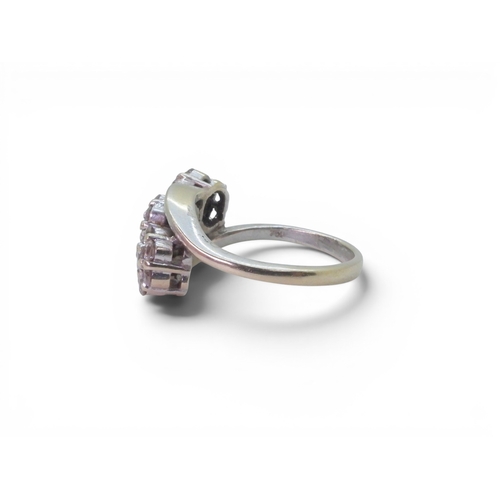 720 - An 18ct white gold ring set with three diamond set flower clusters, with an estimated approx diamond... 