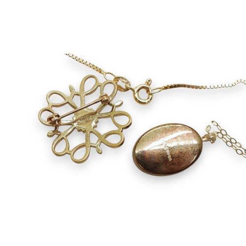 723 - Two Avon long service awards, of a gem set pendant and brooch, together with a locket and two chains... 