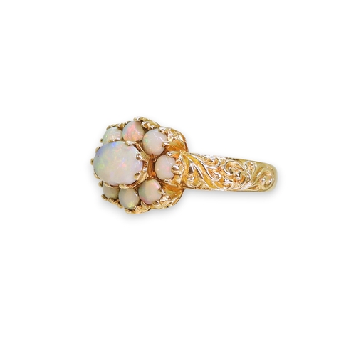 724 - A 9ct gold opal cluster ring, with a decorative scroll mount (two opals af) size P1/2, weight 3.2gms