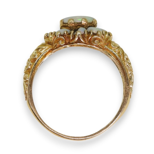 724 - A 9ct gold opal cluster ring, with a decorative scroll mount (two opals af) size P1/2, weight 3.2gms