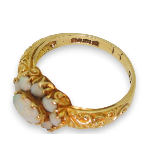 724 - A 9ct gold opal cluster ring, with a decorative scroll mount (two opals af) size P1/2, weight 3.2gms