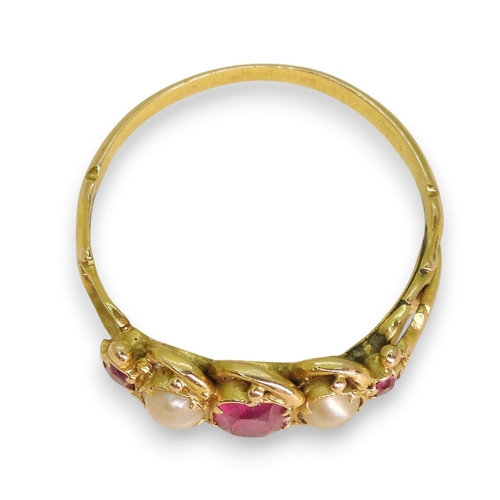 725 - A yellow metal ruby and pearl set ring, size L1/2, weight 1.8gms