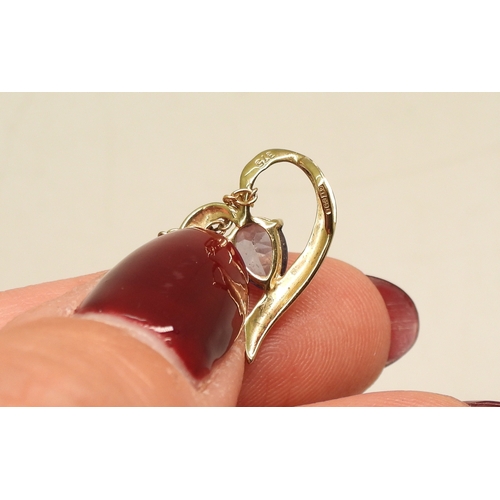 735 - A 9ct gold tanzanite and diamond accent heart shaped pendant and chain, together with a yellow metal... 