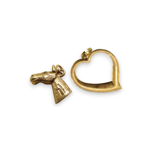 736 - A 9ct gold horse's head charm and a further example in the shape of a croft, a heart shaped pendant ... 