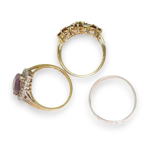 740 - A 9ct white gold wedding ring, size S1/2, a 9ct gold garnet and diamond accent cluster ring, size P1... 