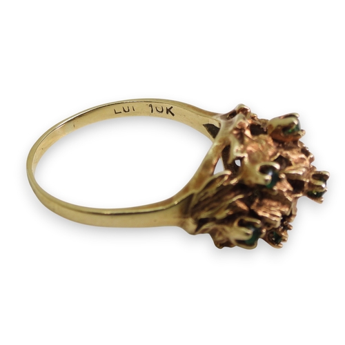 747 - A 10k gold green gem set retro ring, size R1/2, weight 5.2gms