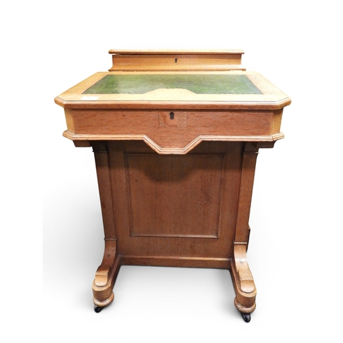 10 - A late 19th century oak Davenport writing desk with hinged top stationary compartment over skiver to... 