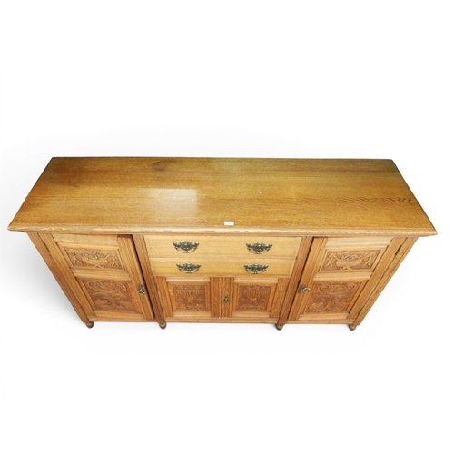 16 - An early 20th century oak sideboard with two central drawers over pair of carved panel doors flanked... 
