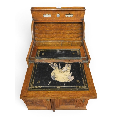 17 - An early 20th century oak writing slope with adjustable day date calendar over tambour topped writin... 