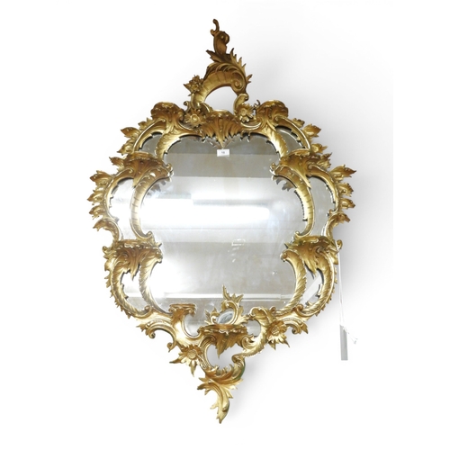 18 - A 20th century Louis XVI style gilt framed wall mirror with scrolled foliate frame, 121cm high x 81c... 
