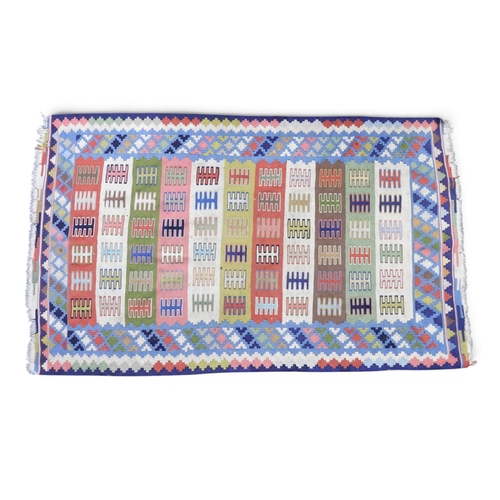 21 - A small multicoloured Kilim rug with striped geometric patterned ground within multicoloured geometr... 