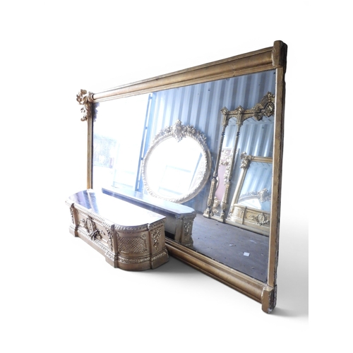 30 - An exceedingly large 19th century giltwood framed wall mirror with moulded column frame capped with ... 