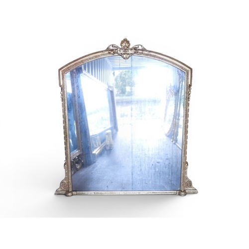 32 - A large 19th century gilt gesso framed overmantle mirror with shaped mirror pane within moulded gess... 
