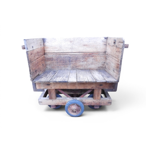 37 - An early 20th century wood and steel framed luggage trolley with handles on either end and open side... 