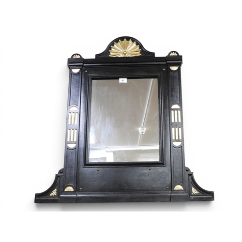 46 - A 20th century cast metal narrow overmantle mirror with arched surmount over rectangular mirror pane... 