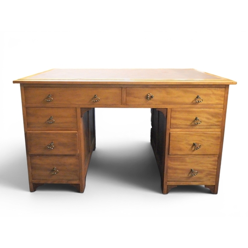 5 - A 20th century beech writing desk with burgundy skiver over two long frieze drawers on three drawer ... 