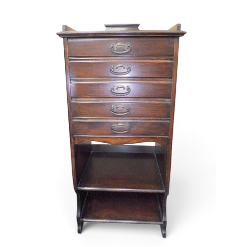 50 - An early 20th century Stones patent music cabinet with five fall front drawers over two open shelves... 