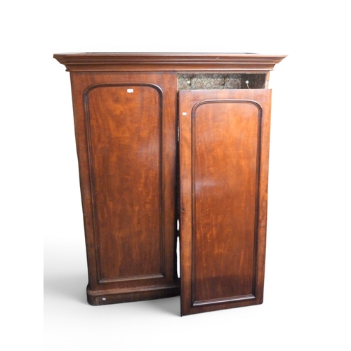 55 - A Victorian mahogany wardrobe with moulded cornice over pair of panel doors, left door concealing in... 